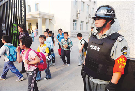 A security guard stands watch outside a primary school in Beijing.