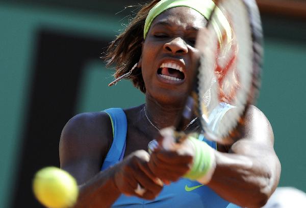 USA's Serena Williams returns the ball to Switzerland's Stefanie Voegele during their first round match of the French Open tennis tournament at the Roland Garros stadium in Paris, Monday, May 24, 2010. (Xinhua/Luo Lang)