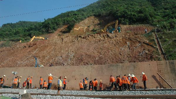 Railway workers reinforces the subgrade at a section of the Shanghai-Kunming railway line in Dongxiang County, east China's Jiangxi Province, May 24, 2010. 