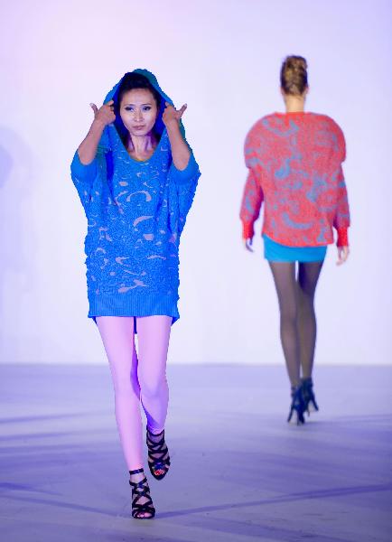 A model presents a creation by designer Lee Ka Yan during a knitwear fashion show of graduating students from the Hong Kong Polytechnic University's Institute of Textiles and Clothing in Hong Kong, south China, on May 25, 2010.