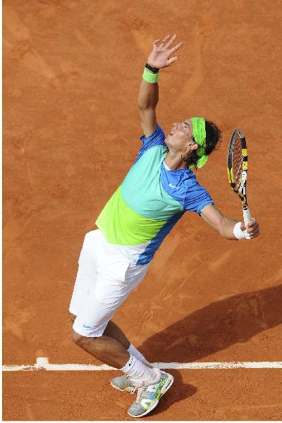 Rafael Nadal of Spain serves to Gianni Mina of France during the men's singles first round match at the French Open tennis tournament at Roland Garros, Paris, capital of France, May 25, 2010. Nadal won 3-0. (Xinhua/Laurent Zabulon) 