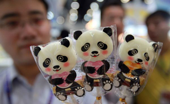 A man shows a kind of candy in the shape of panda during the 2010 China Beijing International Snack Food Exhibition held in Beijing, May 25, 2010. A total of 181 enterprises from 14 countries and regions took part in the exhibition that opened on Tuesday.