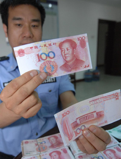 A policeman shows the counterfeits. 