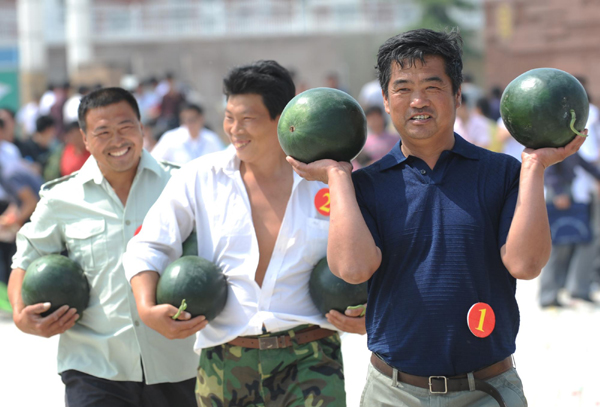Farmers take part in the watermelon festival in Zhongmu county of Zhengzhou city, capital of Central China's Henan province, May 25, 2010.