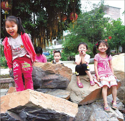 Kids play on inkstone slabs in White Stone Village, Zhaoqing.