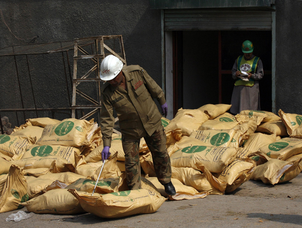 A security official examines sacks of explosives in Lahore, Punjab province March 16, 2010. [Xinhua/Reuters File Photo]