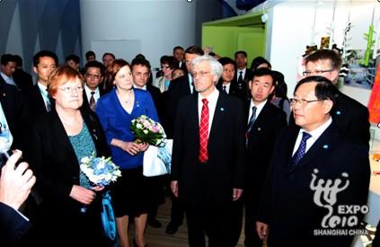 Officials tour the Finland Pavilion.