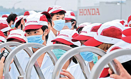 Workers at a Honda parts maker in Foshan, Guangdong province, go on a strike on Wednesday after their demand for higher pay was rejected. The strike continued on Thursday.