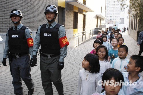 Two guards patrol at a primary school in Beijing. (CNS File Photo) 