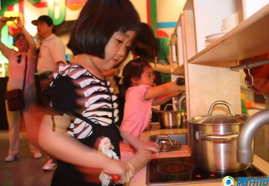 Kids enjoy cooking inside the Sweden Pavilion.