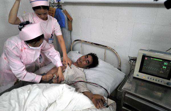 Zeng Taisheng (on the stretcher) is treated by the nurses as he left the People's Hospital of Rucheng County, central China's Hunan Province, May 31, 2010. Zeng Taisheng, the only survivor of an explosion at the Shuguang Coal Mine in Rucheng County of Chenzhou City, was transfered to Yuebei Hospital in Guangdong Province's Shaoguan City on Monday. 