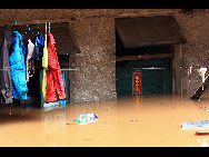 A house is flooded in Laichenggang City, south China's Guangxi Zhuang Autonomous Region, June 1, 2010, due to the continuing severe rain and storm. [Xinhua]