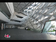 The 'Twin Boulder' is designed by London-based architect Zaha Hadid. The building takes its shape from boulders in the Zhujiang River that runs through the city of Guangzhou. The Big Boulder is the major theater of the Center, with 1800 seats, while the small boulder houses a multi-function theater with 400 seats. [Photo by Huang Yan]