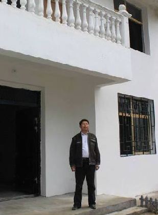 Zhang Longfu, a 48-year-old farmer, is checking his new residence, where he is going to move in by the end of August. This is the second migration for him in 40 years.[China.org.cn]