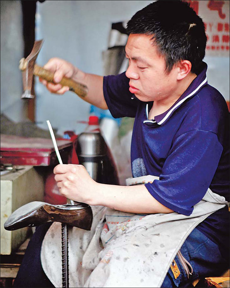 Wang Jiakui, who runs a shoe repair business in Tangjialing, said he will stay open until the demolition crews arrive. 
