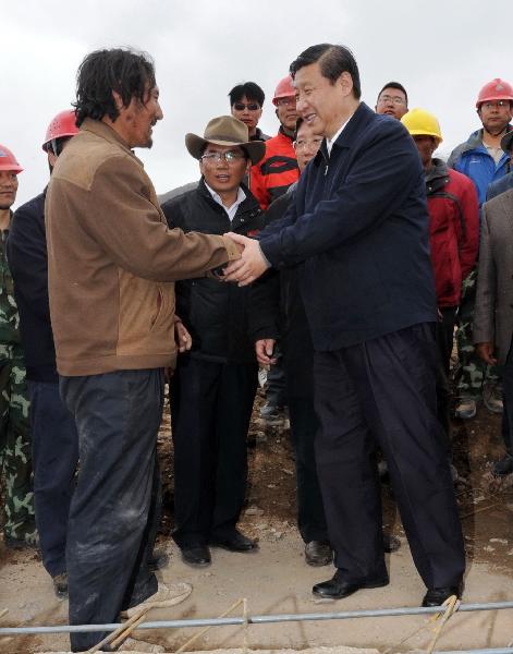 Chinese Vice President Xi Jinping(R front) shakes hands with a construction worker in quake-hit Yushu County, northwest China's Qinghai Province, June 1, 2010. 