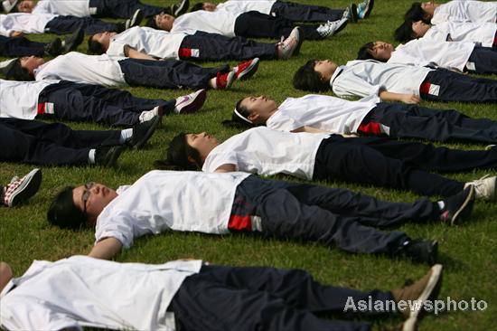 High school students take part in group exercises at Ningbo Economy and Trade School, six days ahead of the Chinese national college entrance examination, or Gaokao, in Zhejiang province, June 1, 2010. The examination, to be held June 7-8, is the most important test for high school seniors to get admitted into college. [Photo/Asianewsphoto] 