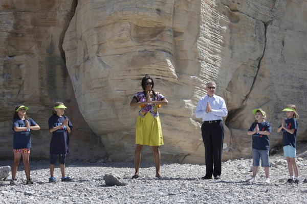 First Lady Michelle Obama (3rd L) and Senate Majority Leader Harry Reid (D-Nev.) take part in an exercise activity with children at the Red Rock Canyon National Conservation Area near Las Vegas, Nevada June 1, 2010. 