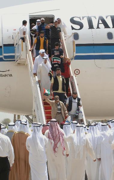 Kuwaiti Pro-Palestinian activists, who were detained aboard the Gaza-bound flotilla raided by Israel on May 31, 2010, arrive at the Kuwait international airport in Kuwait City on June 2, 2010. Israel deported all of the Gaza aid flotilla activists on Wednesday. [Xinhua]