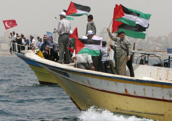 Palestinians attend a protest against the Israeli attack on Gaza Freedom Flotilla on the sea near Gaza, June 3, 2010. [Xinhua]