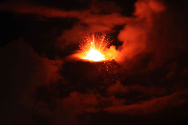 The Tungurahua volcano spews ash and rocks during an eruption in Banos, about 130 km (81 miles) southeast of Quito, June 2, 2010. Tungurahua has been classed as active since 1999 and had a strong eruption in 2008. It is one of eight active volcanoes in the country.[Xinhua]