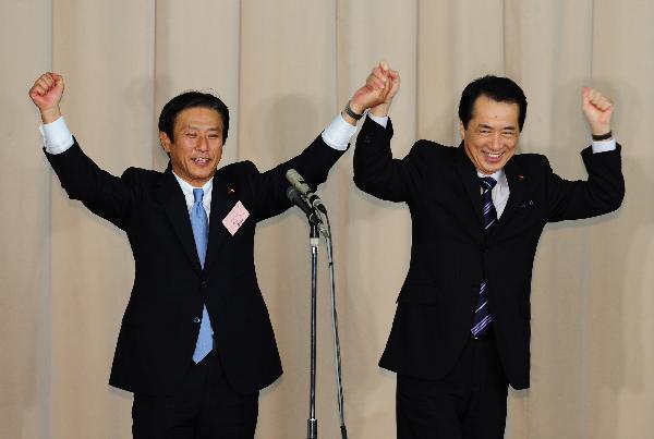 Naoto Kan (R) gestures after he won the election to succeed the outgoing Prime Minister Yukio Hatoyama as the Democratic Party of Japan (DPJ) leader in Tokyo, capital of Japan, on June 4, 2010. [Xinhua]