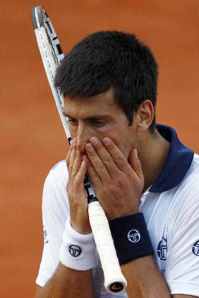 Serbia's Novak Djokovic reacts to a lost point during his men's quarter-final match against Austria's Jurgen Melzer in the French Open tennis championship at the Roland Garros stadium. Metzer won 3-6, 2-6, 6-2, 7-6 (7/3), 6-4. (Xinhua/Reuters Photo)