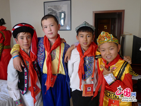 Delegates from the Tajik (first from the left), Kirgiz (second from the left), Uyghur (second from the right) and Xibe (right) ethnic groups