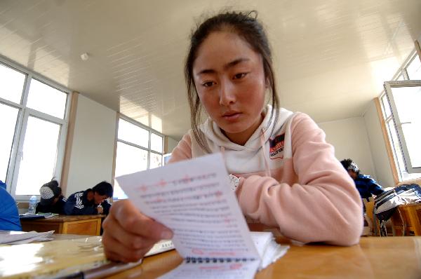 A student of No. 2 Nationalities High School reviews the lessons 4 days before the nation-wide college entry exam in a makeshift-classroom in the quake-hit Yushu County, northwest China's Qinghai Province, June 3, 2010. The nation-wide exam will start next Monday. 