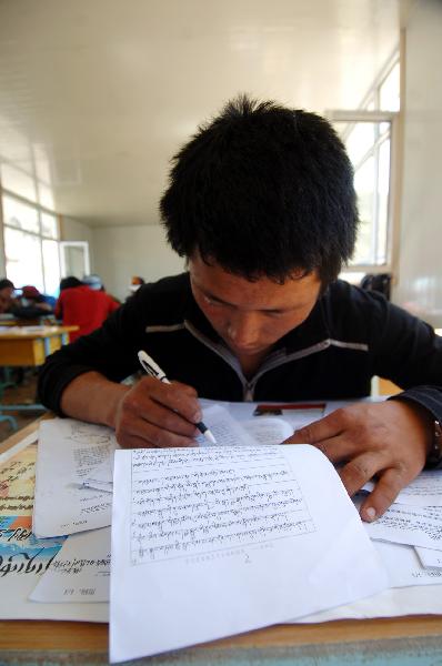 A student of No. 2 Nationalities High School reviews the lessons 4 days before the nation-wide college entry exam in a makeshift-classroom in the quake-hit Yushu County, northwest China's Qinghai Province, June 3, 2010. The nation-wide exam will start next Monday.