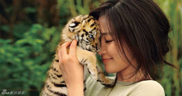 Chinese Actress Li Bingbing poses with a three-month-old tiger for 'Psychologies' magazine. The ambassador of the World Wildlife Fund for Nature (WWF) aims to raise public awareness about protecting wild animals. 