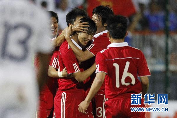 China's soccer players celebrate after scoring against France in their friendly soccer match at Michel Volnay stadium in the French overseas territory of La Reunion June 4, 2010.