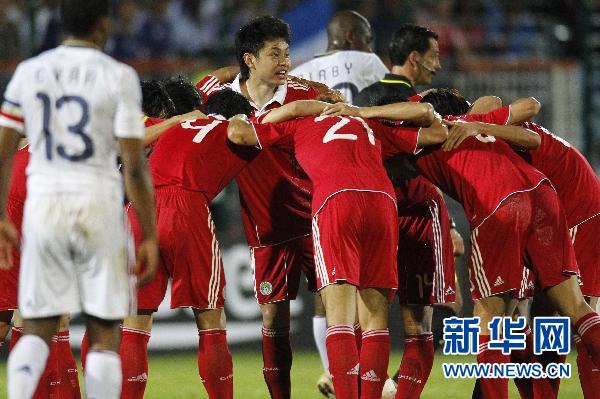 China's soccer players celebrate after scoring against France in their friendly soccer match at Michel Volnay stadium in the French overseas territory of La Reunion June 4, 2010.