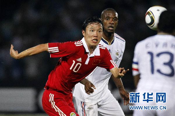 France's national soccer team players struggles with China's player during their friendly soccer match at Michel Volnay stadium on the French overseas territory of La Reunion June 4, 2010.