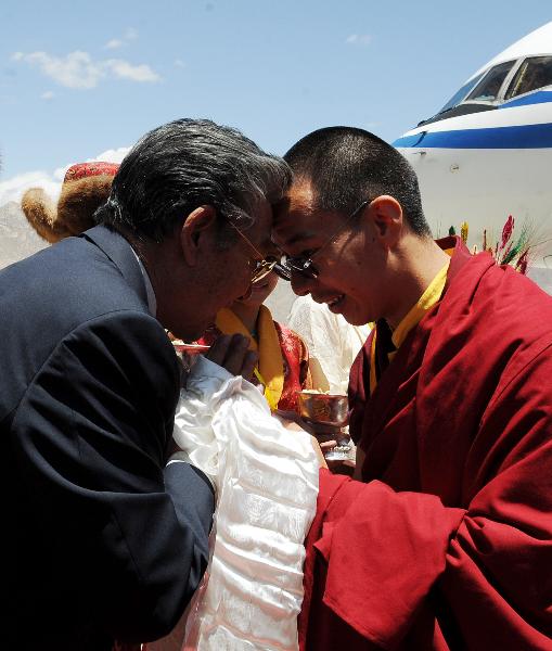 The 11th Panchen Lama (R) greets Pagbalha Geleg Namgyae, vice chairman of the National Committee of the Chinese People&apos;s Political Consultative Conference (CPPCC), who is also chairman of Tibet Autonomous Regional Committee of CPPCC, upon Panchen Lama&apos;s arrival in Lhasa, capital of southwest China&apos;s Tibet Autonomous Region, June 4, 2010. The 11th Panchen Lama arrived at Lhasa for Buddhist activities as an annual routine in recent years. [Chogo/Xinhua]