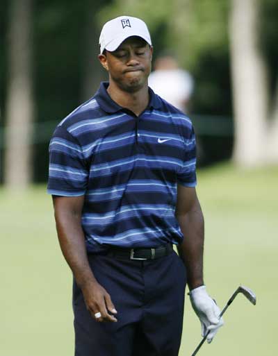 Tiger Woods of the U.S. reacts to his approach shot at the ninth hole during the first round of the Memorial Tournament at Muirfield Village Golf Club in Dublin, Ohio June 3, 2010. 