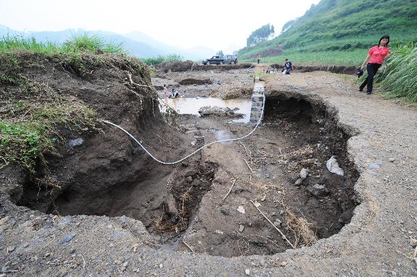 Photo taken on June 6, 2010 shows a road damaged by rainstorms in Shang&apos;e Village of Huangmao Township in Wuxuan Countyship of Laibin City, southwest China&apos;s Guangxi Zhuang Autonomous Region. [Xinhua]