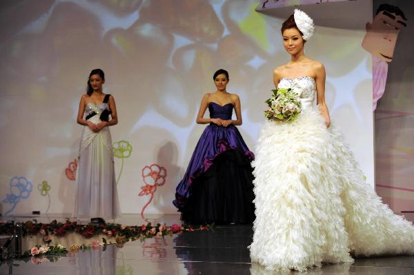 Models display wedding dresses at the Hong Kong Convention and Exhibition Center in Hong Kong on June 6, 2010. The 59th Summer Wedding Service, Banquet and Beauty Expo is held here from June 4 to 6 presenting tens of thousands of wedding dress sorts from 18 countries and regions.