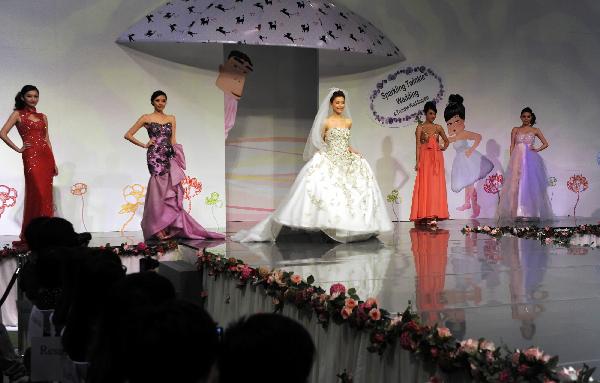 Models display wedding dresses at the Hong Kong Convention and Exhibition Center in Hong Kong on June 6, 2010. The 59th Summer Wedding Service, Banquet and Beauty Expo is held here from June 4 to 6 presenting tens of thousands of wedding dress sorts from 18 countries and regions. 