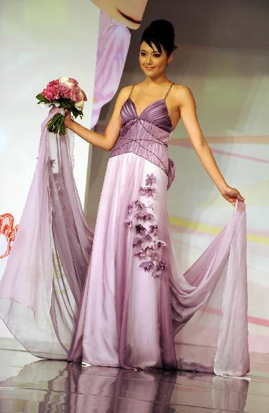 A model displays a wedding dress at the Hong Kong Convention and Exhibition Center in Hong Kong on June 6, 2010. The 59th Summer Wedding Service, Banquet and Beauty Expo is held here from June 4 to 6 presenting tens of thousands of wedding dress sorts from 18 countries and regions.