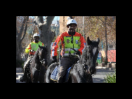 Mounted policemen patrol outside the Ellis Park Stadium in Johannesburg, June 7, 2010. Some 44,000 South African policemen will be on duty during the World Cup games. [Xinhua]