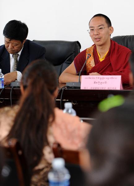The 11th Panchen Lama (R) talks with students at Tibet University in Lhasa, capital of southwest China's Tibet Autonomous Region, June 9, 2010. The 11th Panchen Lama visited Tibet University and Tibet College of Tibetan Medicine in Lhasa on Wednesday. (Xinhua