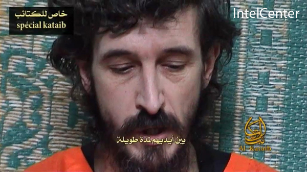 In this image released by the SITE Intelligence Group shows captive French security advisor Denis Allex, addressing his message to the people of France. He appears in two scenes in the same room, one with Shabaab fighters standing behind him and the other by himself, and wears an orange outfit and reads from sheets of paper. [Xinhua]