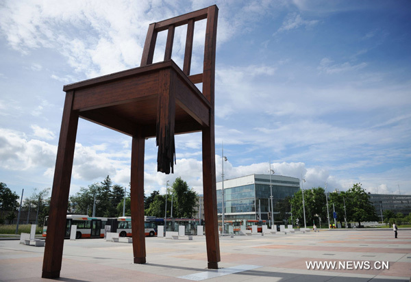 The 'Broken Chair' sculpture is seen on the square in front of the Palace of Nations in Geneva, Switzerland, June 9, 2010. The Palace of Nations in Geneva was built between 1929 and 1936 as the headquarters of the League of Nations. It has served as the home of the United Nations Office in Geneva since 1946, when the UN secretary general signed the Headquarters Agreement with the Swiss authorities, although Switzerland did not become a UN member until 2002. [Xinhua/Yu Yang]