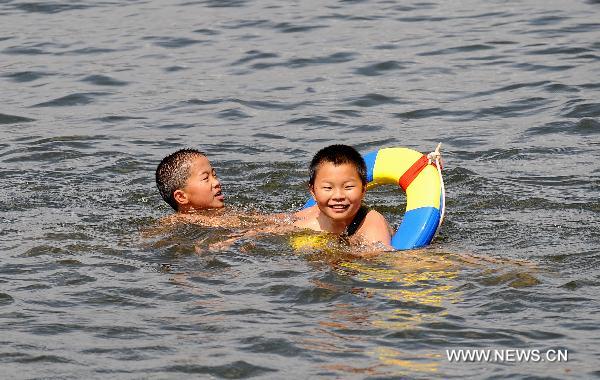 Two boys swim in the Erhai Lake in Bai Autonomous Prefecture of Dali, southwest China&apos;s Yunnan Province, June 6, 2010. [Xinhua]