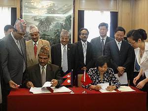 China delegate Ms. Yin Hong (R) and Mr. Yuba Raj Bhusal, Secretary of Ministry of Forests and Soil Conservation Government of Nepal signing the MOU. 