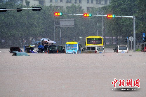 Cars and buses are seen trapped in a waterlogging street in Wuzhou, Guangxi Zhuang Autonomous Region of south China. Heavy rainstorm hit Wuzhou on June 9, 2010, causing severe waterlogging in the area.[Chinanews.com.cn]