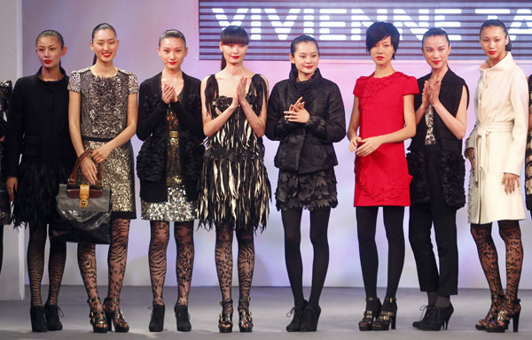 Models pose after a fashion show of designer Vivienne Tam in the World Trade Centers Association (WTCA) Pavillion in the World Expo Park in Shanghai, east China, on June 9, 2010. 