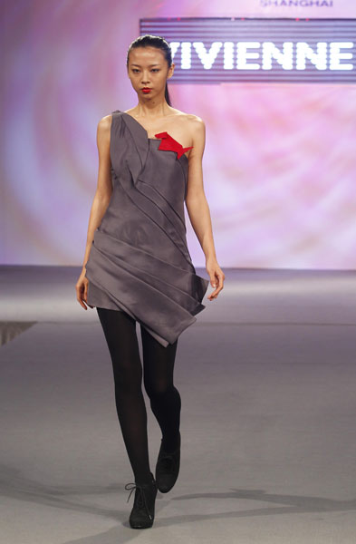 A model presents a creation of fashion designer Vivienne Tam during a fashion show in the World Trade Centers Association (WTCA) Pavillion in the World Expo Park in Shanghai, east China, on June 9, 2010. 