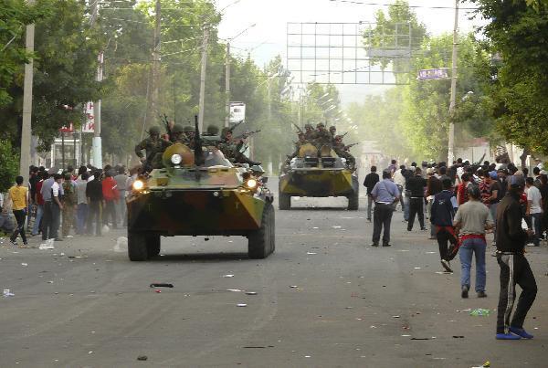 Servicemen drive armoured vehicles in the city of Osh in southern Kyrgyzstan June 11, 2010. At least 12 people were killed and 126 were wounded during the violence in southern Kyrgyzstan on Friday, the Health Ministry said. [Xinhua]